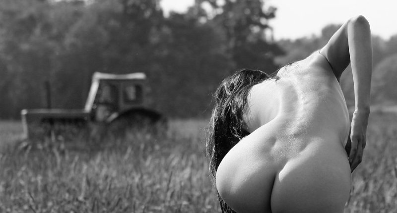 Naked female butt in the field, Erotic photo shoot in the field, Girl on a tractor